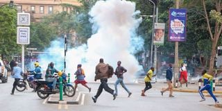 People run for cover after police threw tear gas 