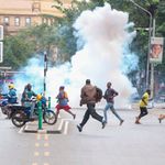 People run for cover after police threw tear gas 