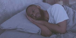 fotosearchmannotsleeping