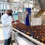 Keroche Production Manager George Otinga inspecting some of the beer bottles at the Naivasha-based factory.