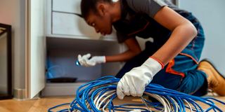 A contractor installing home fibre. 